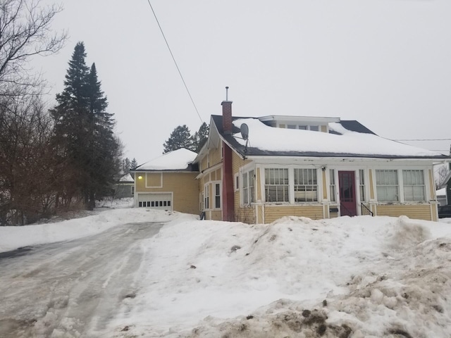 view of front of property featuring a garage and a chimney