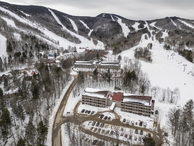 snowy aerial view with a mountain view