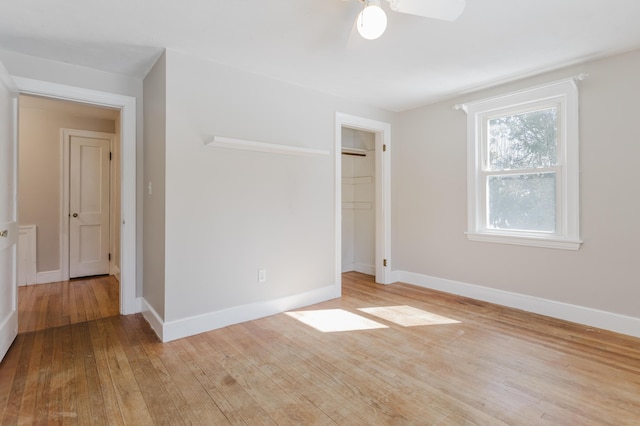 unfurnished room with a ceiling fan, baseboards, and wood finished floors