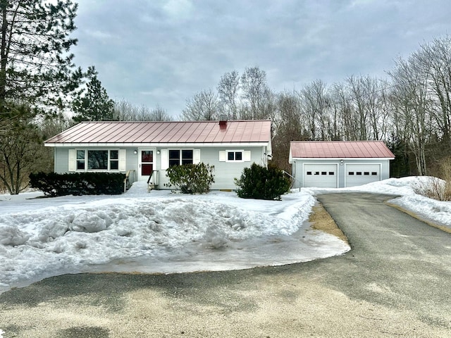 view of front of home with an outbuilding, a standing seam roof, and metal roof