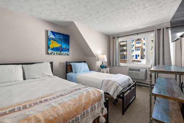 carpeted bedroom featuring a wall unit AC and a textured ceiling