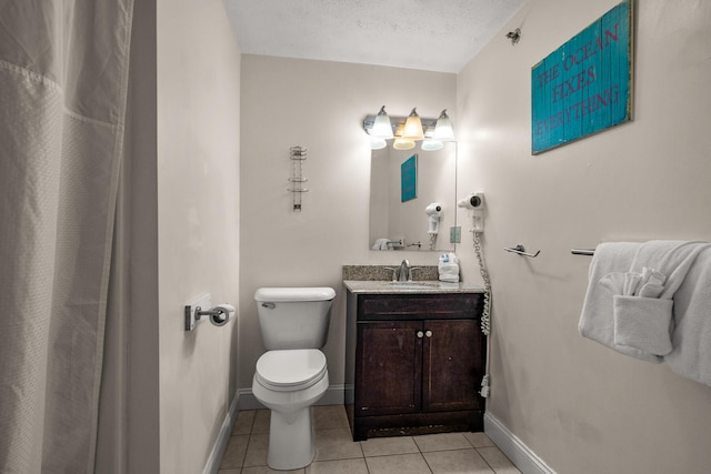 full bath featuring baseboards, toilet, tile patterned flooring, a textured ceiling, and vanity