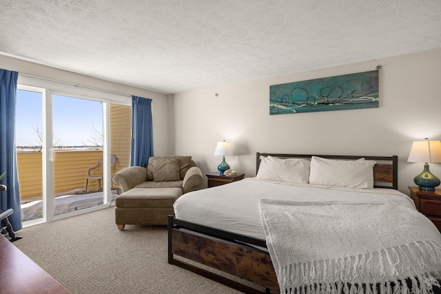 bedroom with a textured ceiling, carpet floors, and access to exterior