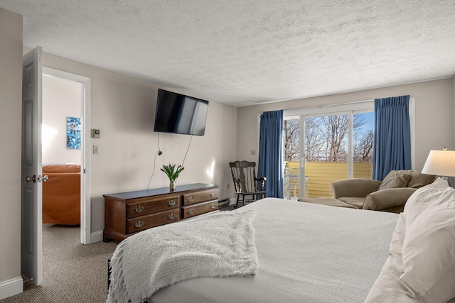 bedroom with a textured ceiling, carpet, and baseboards