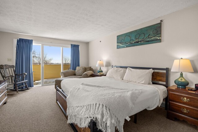 bedroom with a textured ceiling, access to outside, and carpet floors