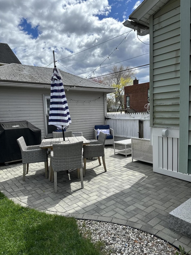 view of patio / terrace with a grill, fence, and an outdoor hangout area