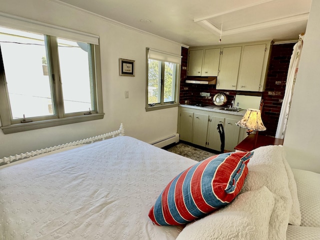 bedroom featuring ornamental molding, baseboard heating, a sink, and attic access