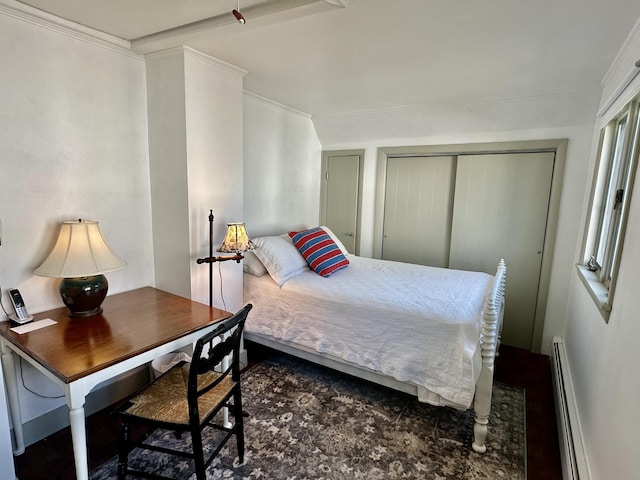 bedroom featuring a closet, a baseboard radiator, and crown molding