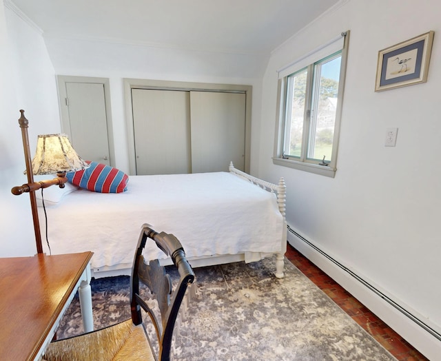 bedroom featuring brick floor, ornamental molding, a closet, and a baseboard radiator