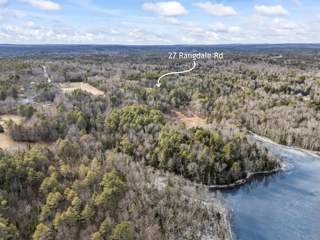 birds eye view of property featuring a forest view