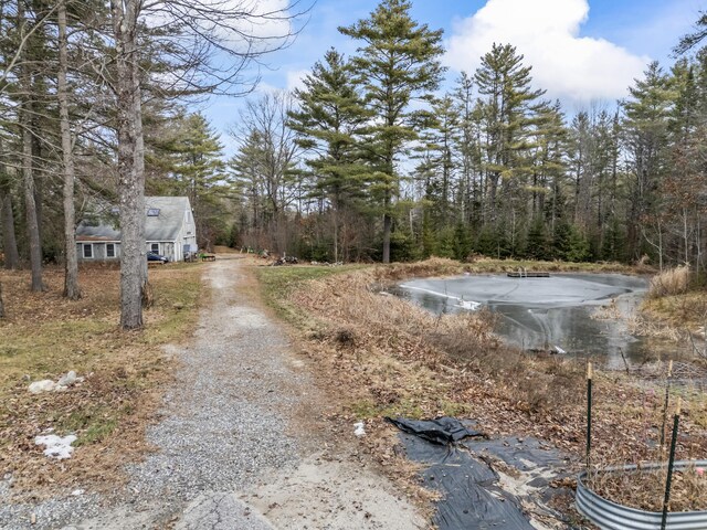 view of street featuring driveway and a water view