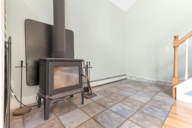 details featuring baseboard heating, a wood stove, and baseboards