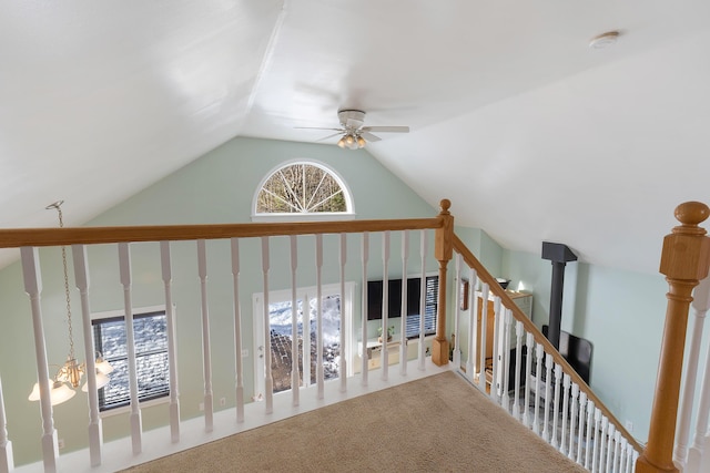 corridor with carpet flooring and high vaulted ceiling