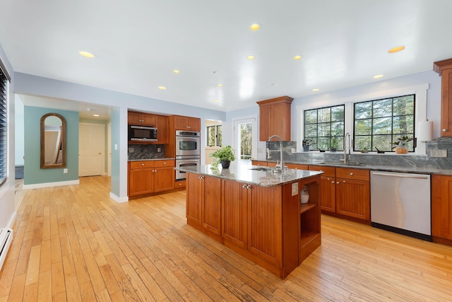 kitchen with a sink, brown cabinets, and appliances with stainless steel finishes