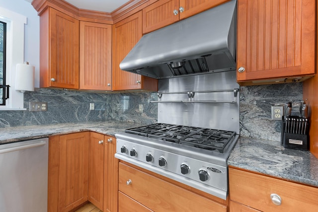 kitchen featuring light stone counters, tasteful backsplash, under cabinet range hood, and stainless steel appliances