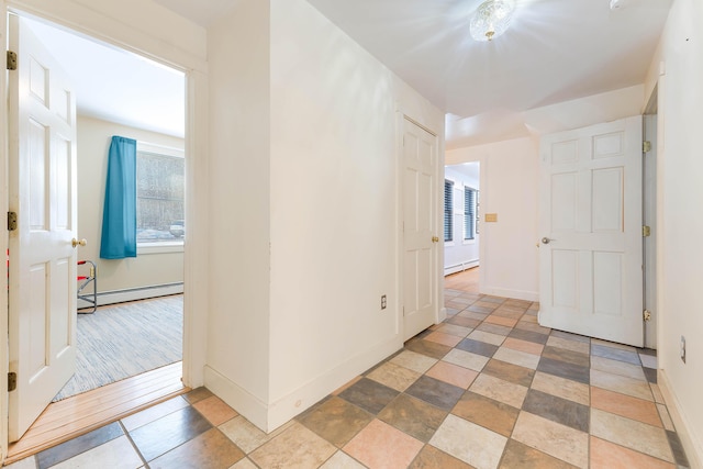 hallway featuring baseboards and baseboard heating