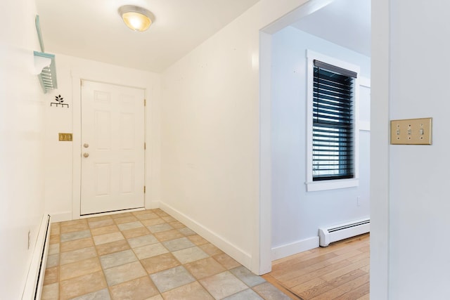 interior space with a baseboard heating unit and baseboards