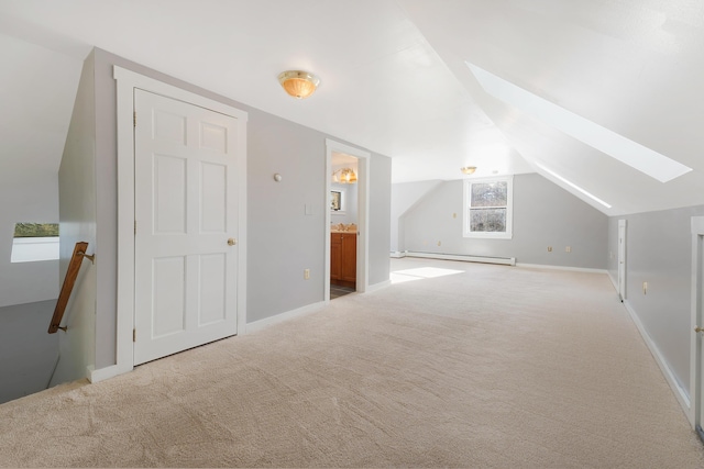 bonus room with lofted ceiling with skylight, carpet, baseboards, and baseboard heating