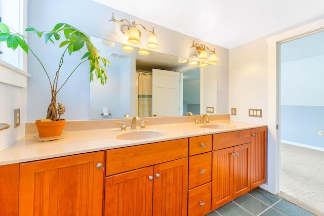 full bathroom with double vanity, baseboards, visible vents, and a sink