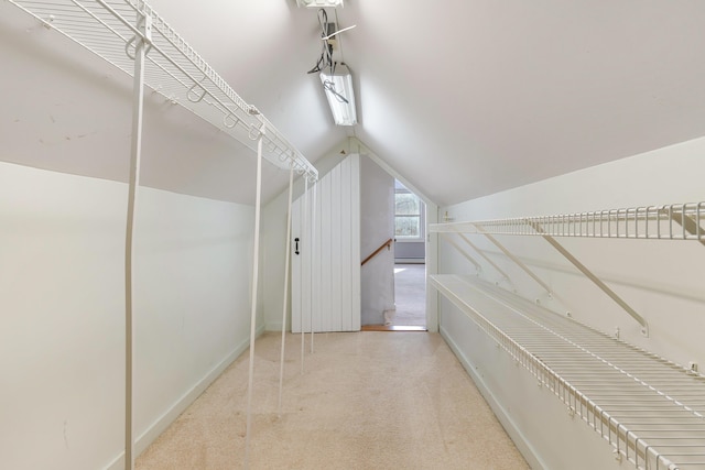 walk in closet with lofted ceiling