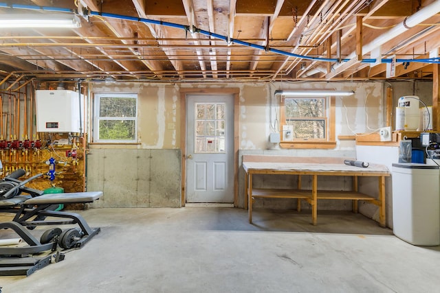 basement featuring water heater and a workshop area