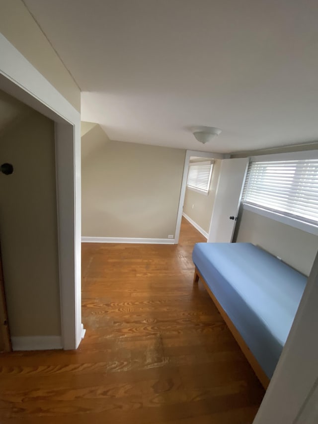 unfurnished bedroom featuring baseboards and wood finished floors