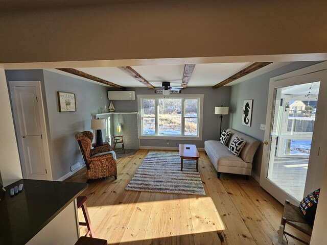 113 Wildes District Rd, Kennebunkport, ME 04046 - living area featuring a ceiling fan, beam ceiling, light wood finished floors, a wall mounted AC, and baseboards