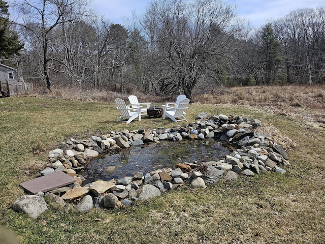 113 Wildes District Rd, Kennebunkport, ME 04046 - view of grassy yard with an outdoor fire pit
