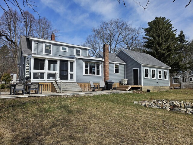 113 Wildes District Rd, Kennebunkport, ME 04046 - back of property with a chimney, a yard, entry steps, a sunroom, and a patio