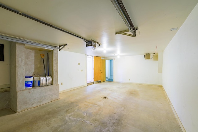 garage featuring baseboards and a garage door opener