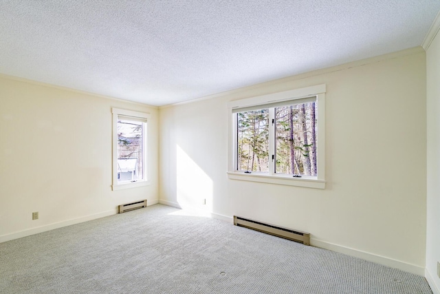 spare room with carpet, a baseboard radiator, ornamental molding, and a textured ceiling