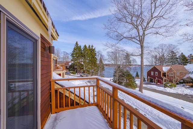 view of snow covered back of property