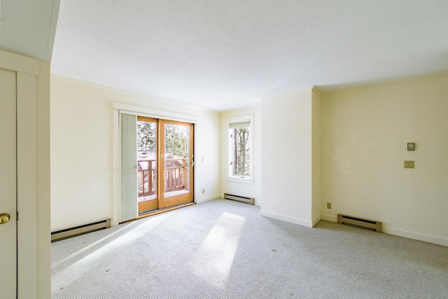 empty room featuring a baseboard radiator, a textured ceiling, and carpet flooring