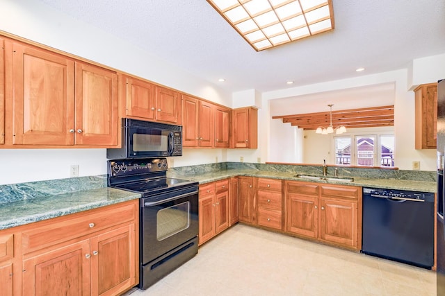 kitchen with black appliances, brown cabinets, a sink, and recessed lighting