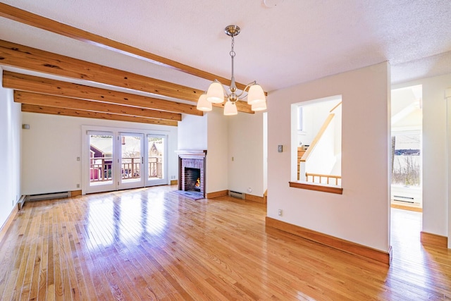 unfurnished living room featuring beamed ceiling, light wood-type flooring, and a notable chandelier