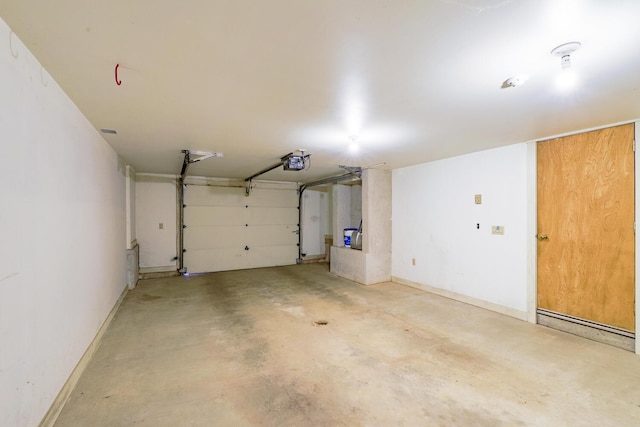 garage with a garage door opener and baseboards