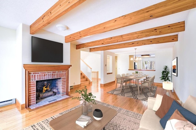 living area featuring baseboards, wood finished floors, baseboard heating, a fireplace, and beam ceiling