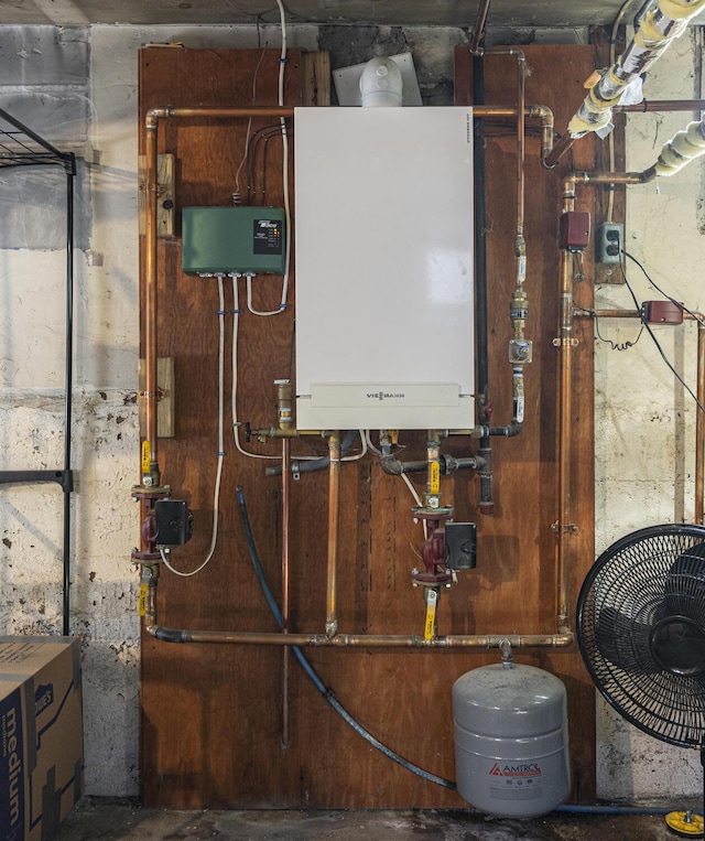 utility room featuring water heater