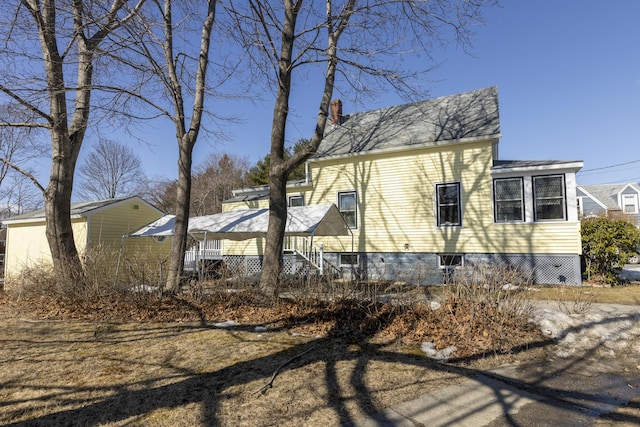 view of front of house featuring a chimney