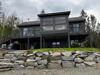 back of house featuring a deck