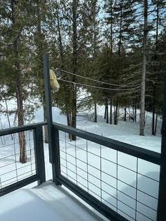 view of snow covered back of property