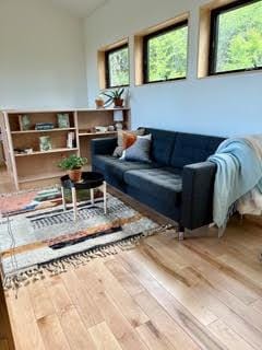 interior space with plenty of natural light, vaulted ceiling, and hardwood / wood-style flooring