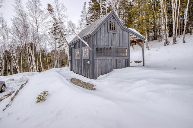 snow covered structure with a garage