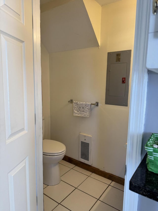 bathroom with electric panel, visible vents, baseboards, toilet, and tile patterned flooring