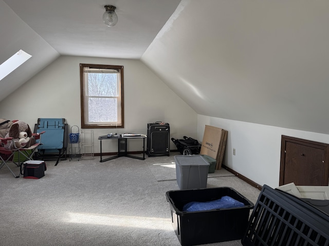 additional living space with lofted ceiling with skylight and light colored carpet