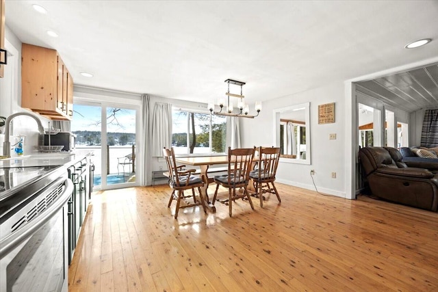 dining area with light wood-style flooring, a notable chandelier, recessed lighting, and baseboards