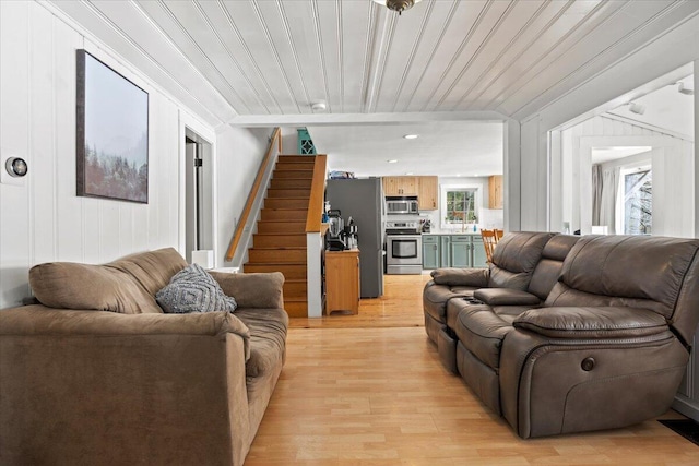 living area with wooden ceiling, stairway, and light wood-style flooring