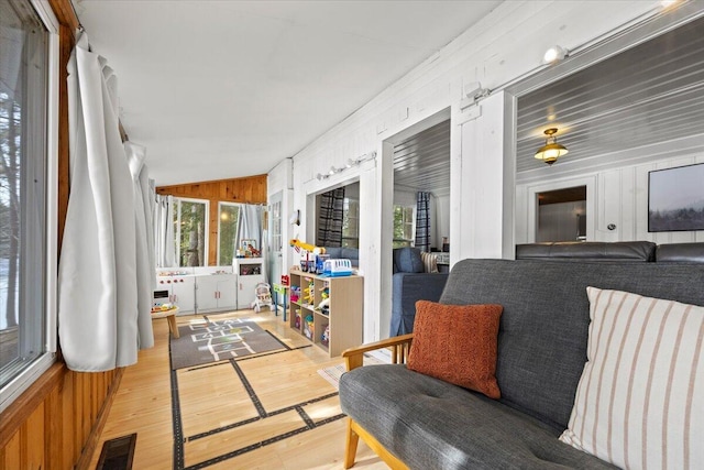 sunroom / solarium with visible vents and vaulted ceiling