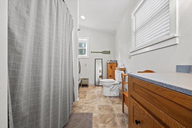 full bathroom featuring a shower with curtain, baseboards, toilet, and lofted ceiling