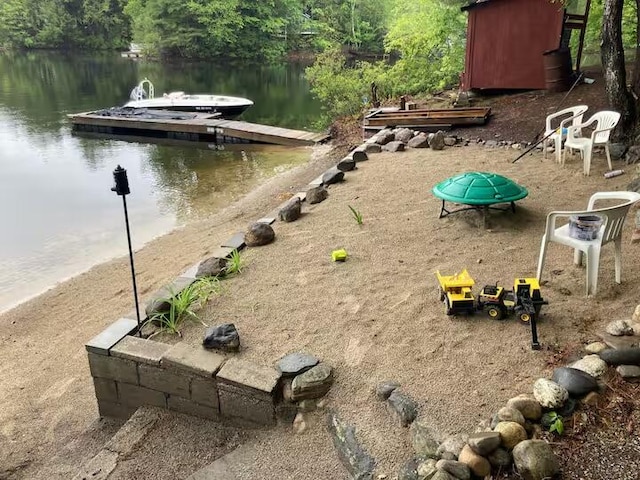 exterior space featuring a water view and a boat dock